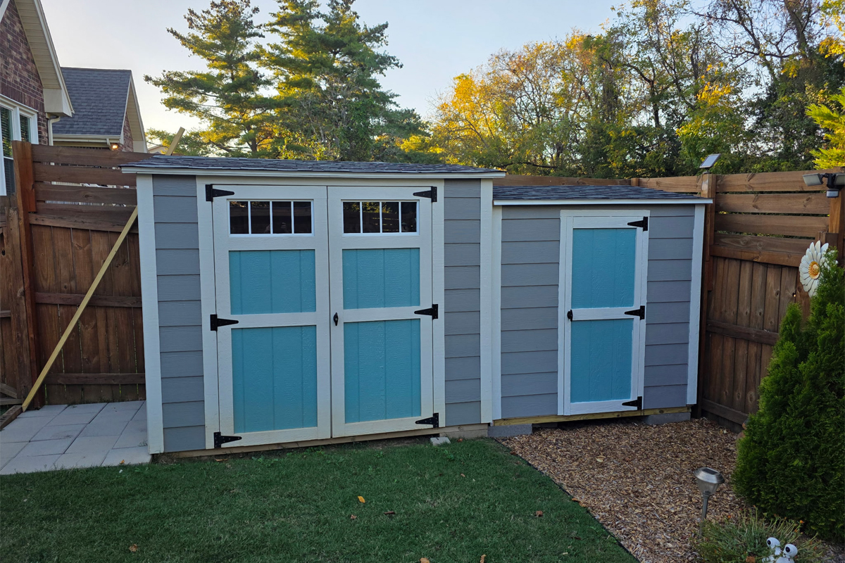 Custom studio with Hardie siding, sliding bard door, and transom windows
